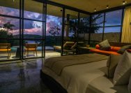 A bedroom with a large bed sitting next to a window