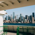 City skyline across the water from a ferry deck.