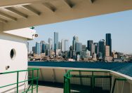 City skyline across the water from a ferry deck.