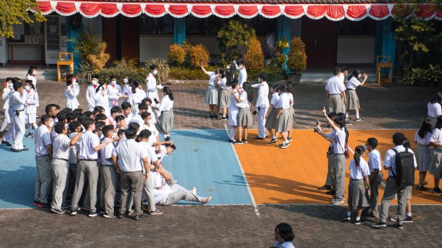 a group of people watching a person do a flip