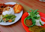 two plates of food on a wooden table