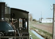 A vintage train moves along a track.