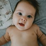 a hand holding a baby