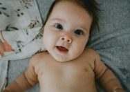 a hand holding a baby