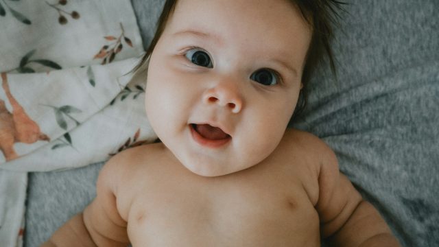 a hand holding a baby