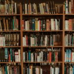 brown wooden book shelf with books