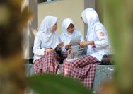 2 women in hijab sitting on chair
