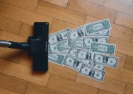 a pile of money sitting on top of a wooden floor
