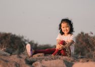 a girl sitting on a rock