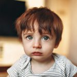 boy in white and black striped crew neck shirt