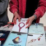 a person drawing on a book