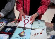 a person drawing on a book