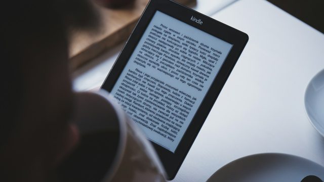 turned on black Amazon Kindle e-book reader