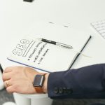 a person writing on a piece of paper