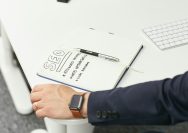 a person writing on a piece of paper