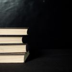 a stack of three books sitting on top of each other