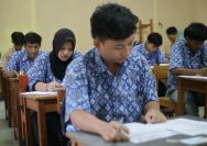 Students are taking a test in a classroom.