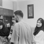 a group of people standing around each other