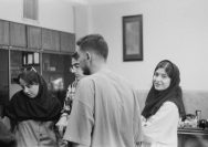 a group of people standing around each other