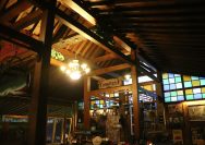 a restaurant with stained glass windows and a wooden ceiling