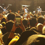 a group of people standing in front of a stage