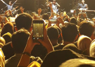 a group of people standing in front of a stage