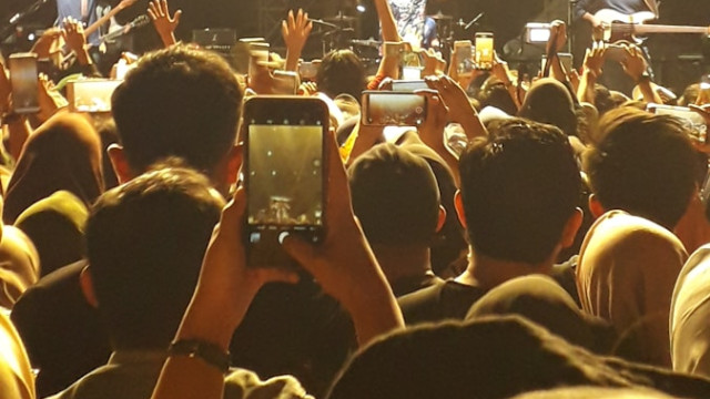 a group of people standing in front of a stage